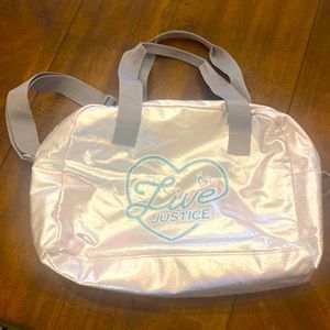 Justice bag silver with glitter blue writing.
